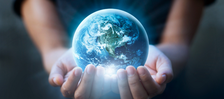 Hands gently cradling a glowing Earth globe.