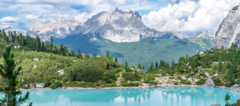 Stunning turquoise alpine lake reflecting dramatic Dolomites mountains.
