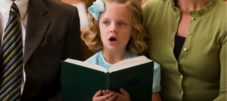 Young girl singing from a hymn book during church service.