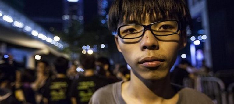 Close-up portrait of Joshua Wong, a prominent figure in Hong Kong's pro-democracy movement.
