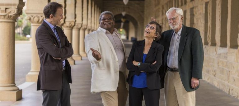Four professionals discussing the future of work, possibly automation's impact.