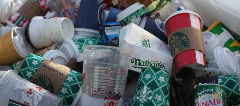 Pile of discarded coffee cups and other trash.