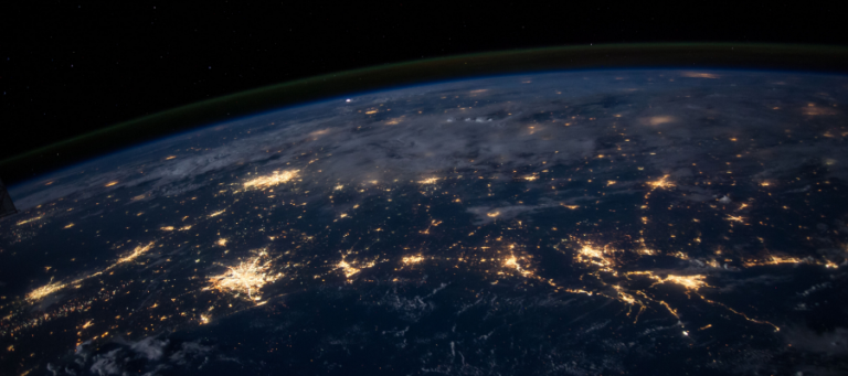 Earth at night, showing city lights.