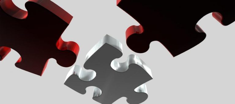 Three interlocking puzzle pieces; two red, one silver.