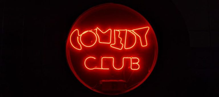 Neon sign reading "COMEDY CLUB