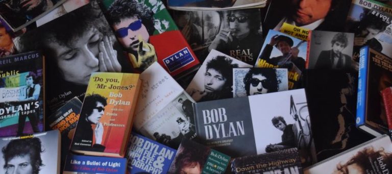 Collection of Bob Dylan books and album covers.