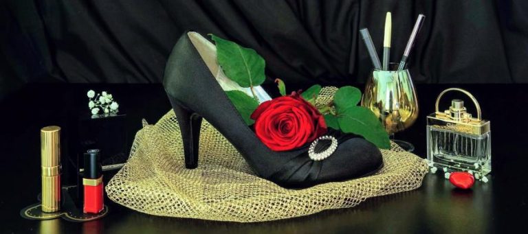 Black high-heeled shoe with red rose and gold mesh