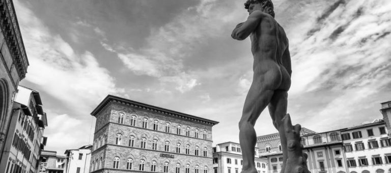 Black and white photo of David statue in Piazza della Signoria, Florence, Italy.