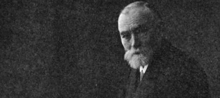Black and white portrait of an older man with a beard, possibly a leader.
