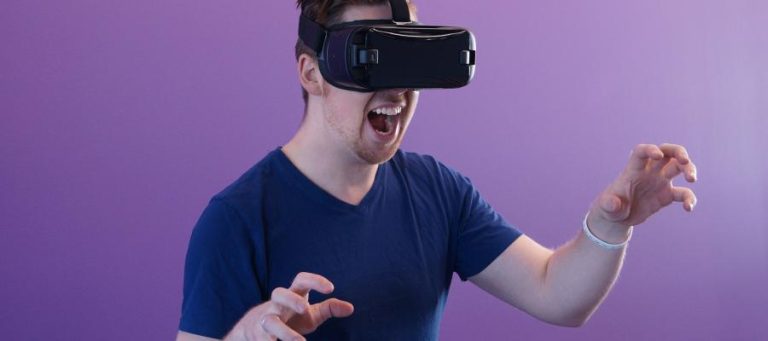 Man wearing VR headset, reacting intensely.