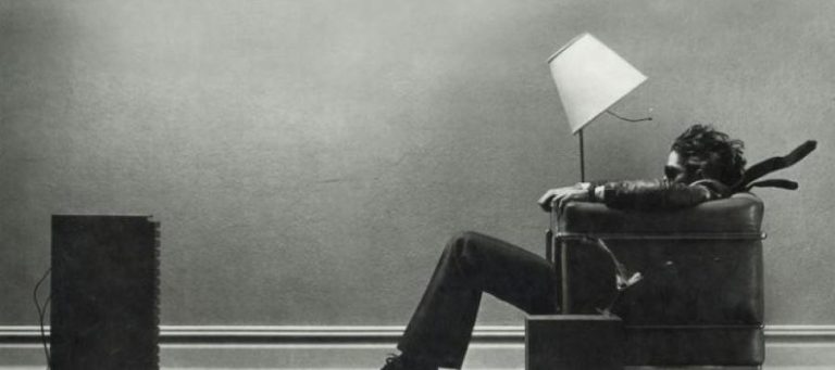 Man slumped in chair, lamp overhead, contemplating a lost republic.