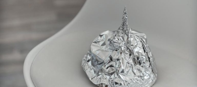 Aluminum foil hat on a chair; a symbol of conspiracy theories.
