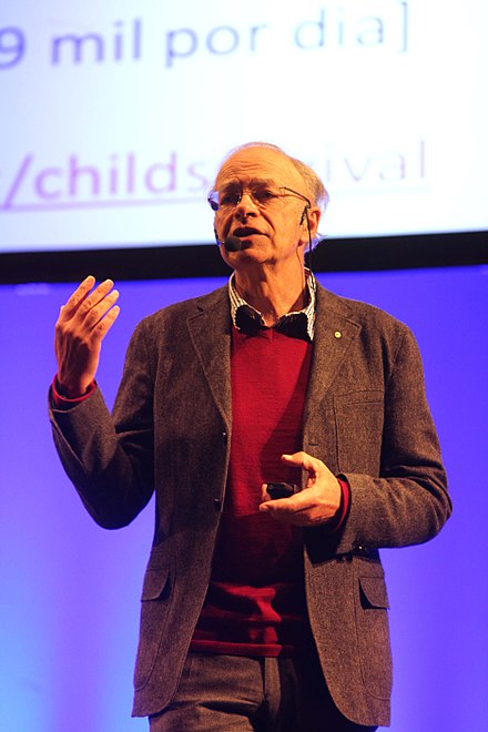 Man giving a presentation on global poverty and international aid.