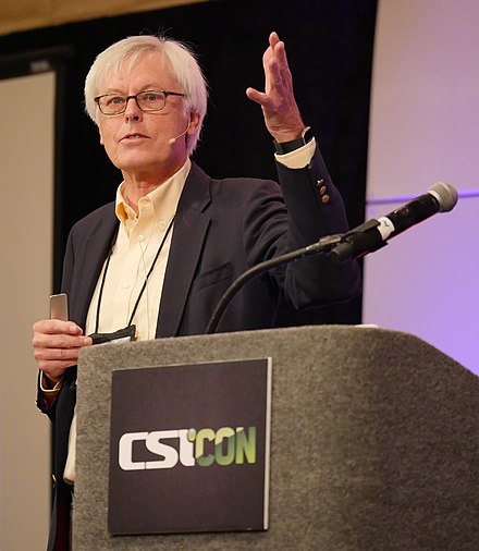 Speaker at science conference presenting on science vs pseudoscience. CSTICON logo visible.