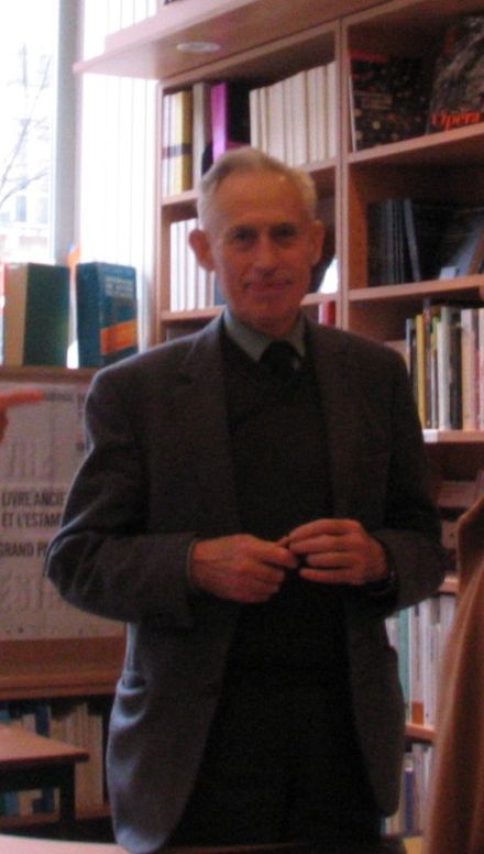 Older man in suit, contemplating the concept of God.