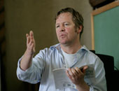 Man gesturing while speaking, possibly lecturing on Confucius