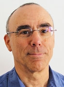 Headshot of a man wearing glasses