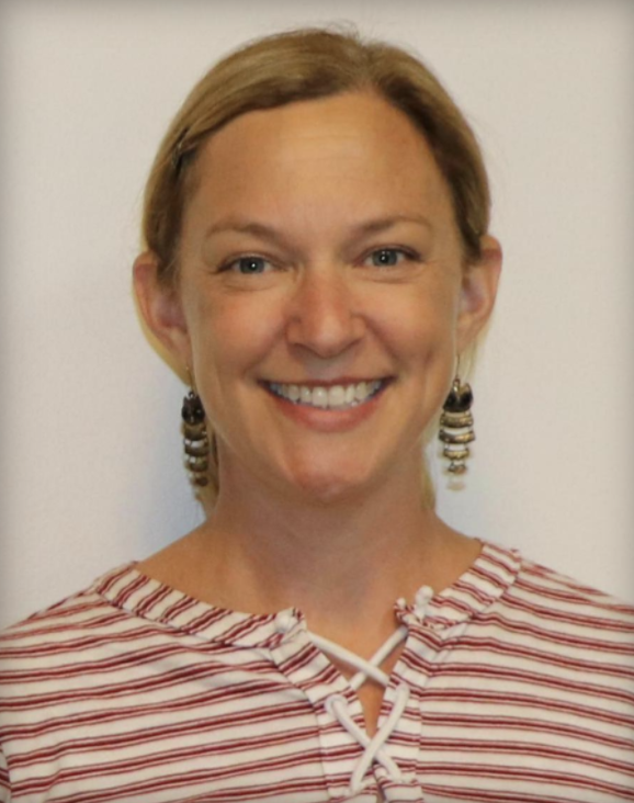 Headshot of a woman with blonde hair wearing a red and white striped shirt.