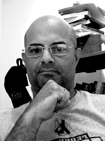 Thoughtful bald man with glasses, displaying skepticism.
