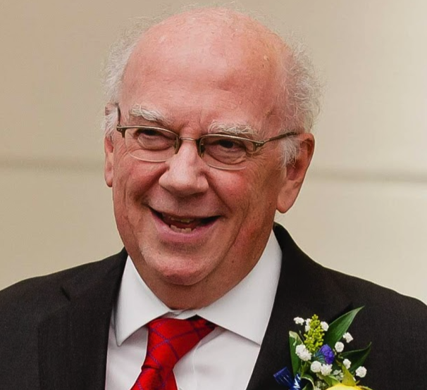 Professor smiling, wearing glasses and a red tie; Philosophy of History
