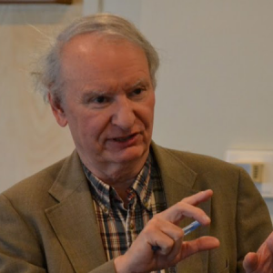 Older man gesturing while speaking