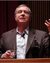 Man in suit speaking at a podium
