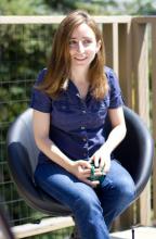 Woman sitting outdoors, smiling