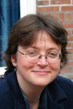 Headshot of a woman, possibly a doctor or researcher discussing paternalism and health.