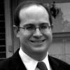 Headshot of a man in a suit and tie